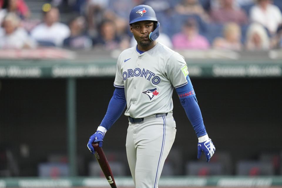 Toronto Blue Jays' Orelvis Martines walks back to the dugout after striking out during the third inning of the team's baseball game against the Cleveland Guardians, Friday, June 21, 2024, in Cleveland. (AP Photo/Sue Ogrocki)