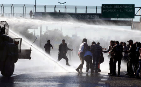 Protestors are sprayed with water by Argentine gendarmerie as they block a road during a 24-hour national strike in Buenos Aires, Argentina, April 6, 2017. REUTERS/Martin Acosta