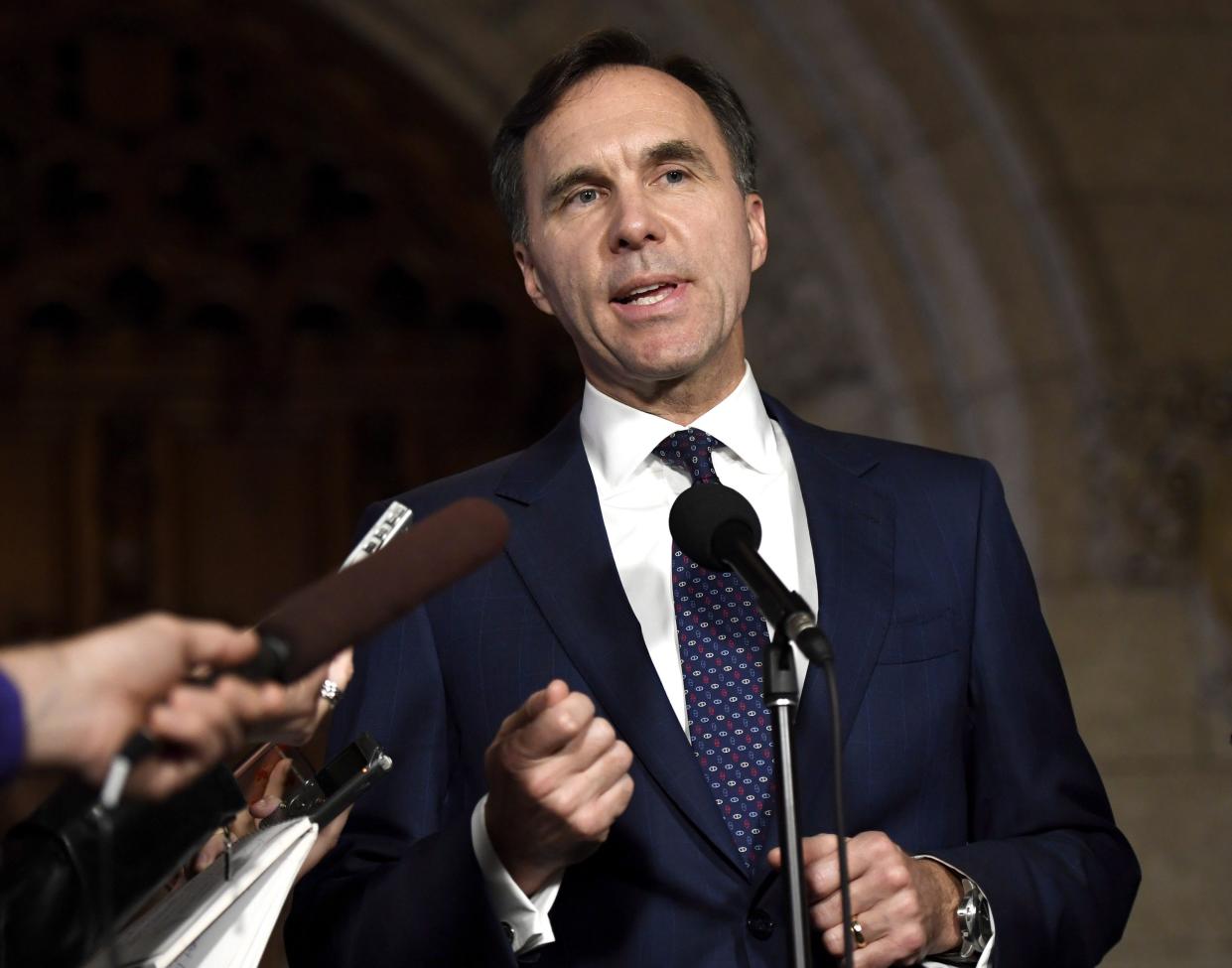 Finance Minister Bill Morneau speaks to reporters in the foyer of the House of Commons on Parliament Hill on Oct. 26, 2017.