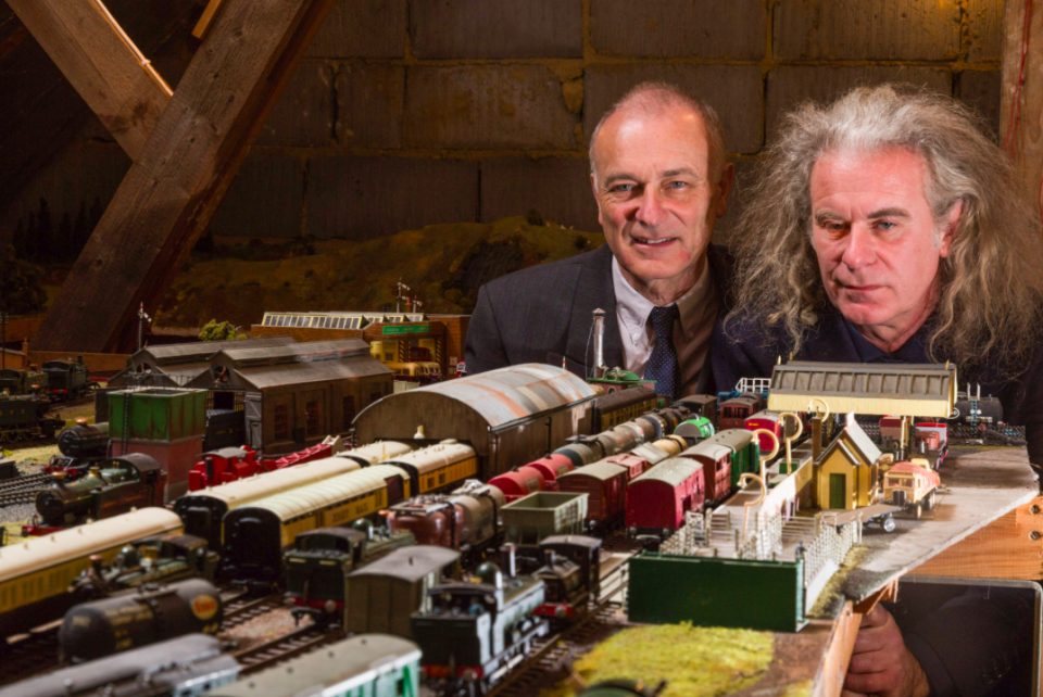 <em>Brothers Simon and Paul Hurst have some of their late father’s ashes carried around his extensive model railway in the loft of his home (SWNS)</em>