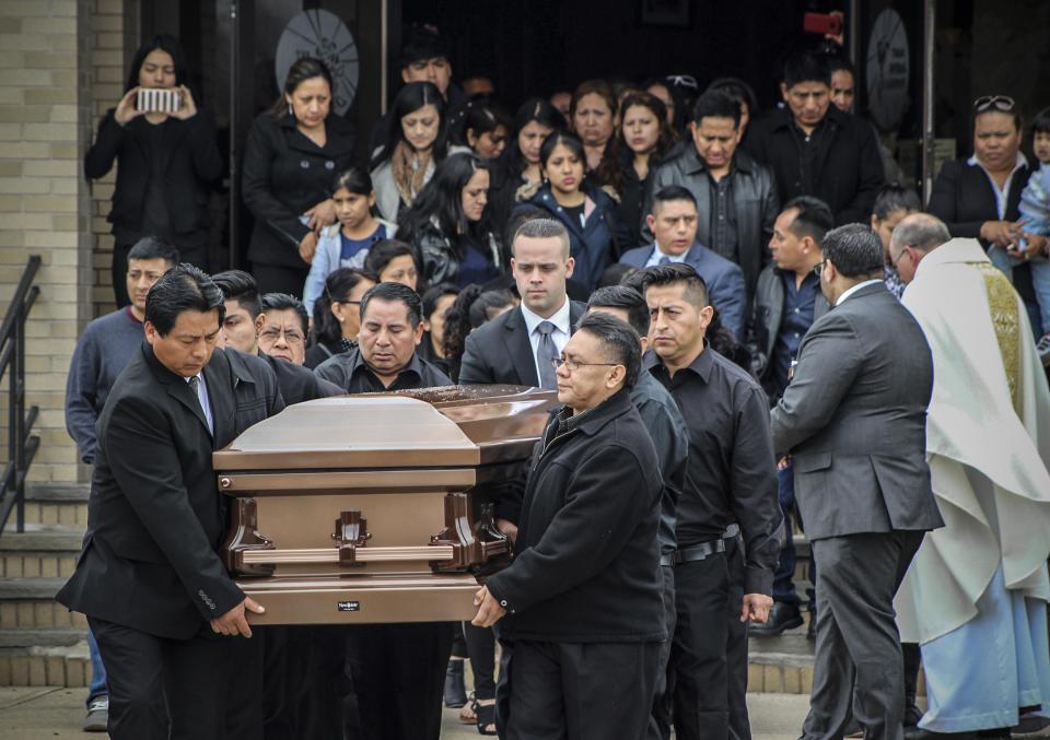 The casket of Justin Llivicura, one of four young men found slain in a suspected MS-13 gang killing, is carried from St. Joseph the Worker Church after Llivicura's funeral, April 19, 2017, in East Patchogue, N.Y.  / Credit: Frank Eltman / AP