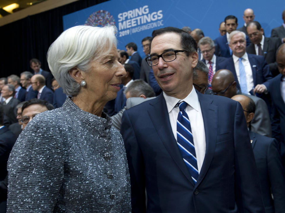 International Monetary Fund (IMF) Managing Director Christine Lagarde speaks with Treasury Secretary Steven Mnuchin during the International Monetary Fund IMF Governors group photo at the World Bank/IMF Spring Meetings in Washington, Saturday, April 13, 2019. (AP Photo/Jose Luis Magana)