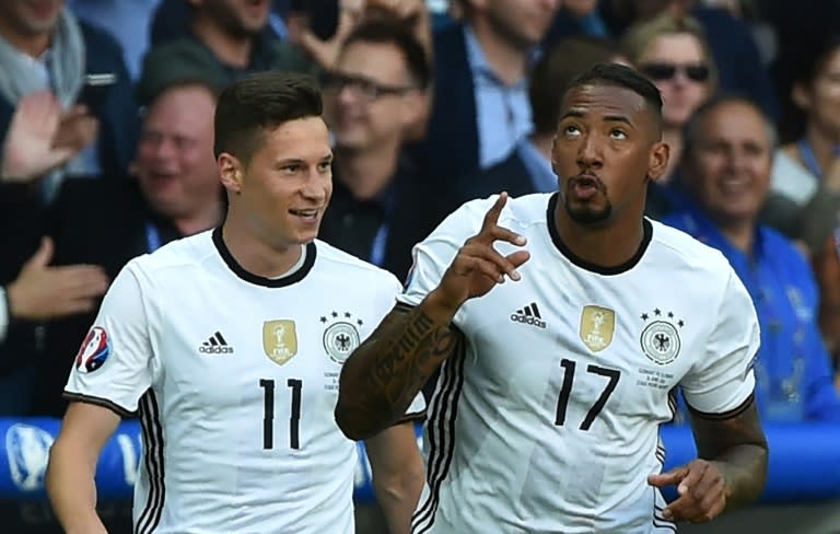 Germany's Jerome Boateng (R) celebrates with teammate Julian Draxler after scoring a goal during their Euro 2016 round of 16 match against Slovakia, at the Pierre-Mauroy stadium in Villeneuve-d'Ascq, on June 26, 2016