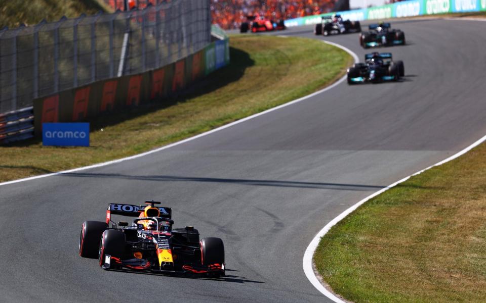 Red Bull Racing RB16B Honda leads Lewis Hamilton of Great Britain driving the (44) Mercedes AMG Petronas F1 Team Mercedes W12 during the F1 Grand Prix of The Netherlands at Circuit Zandvoort on September 05, 2021 in Zandvoort, Netherland - Formula 1/Formula 1 via Getty Images