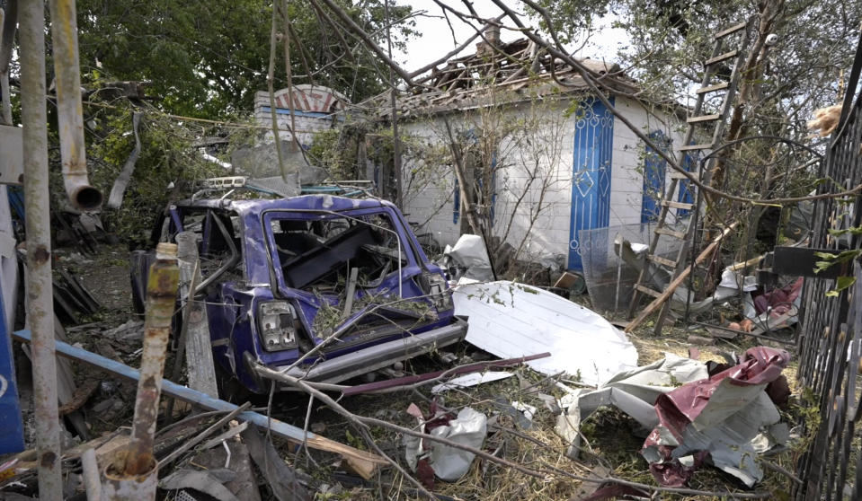 In this frame grab provided from AP TV, a site of destroyed houses seen after a Russian attack in the village Chaplyne, Ukraine, Thursday, Aug. 25, 2022. The death toll from a Russian rocket attack on a train station and the surrounding area as Ukraine celebrated its Independence Day climbed to 25, including at least two children, Ukrainian authorities said Thursday. Russia said it targeted a military train and claimed to have killed more than 200 Ukrainian reservists. (AP Photo)