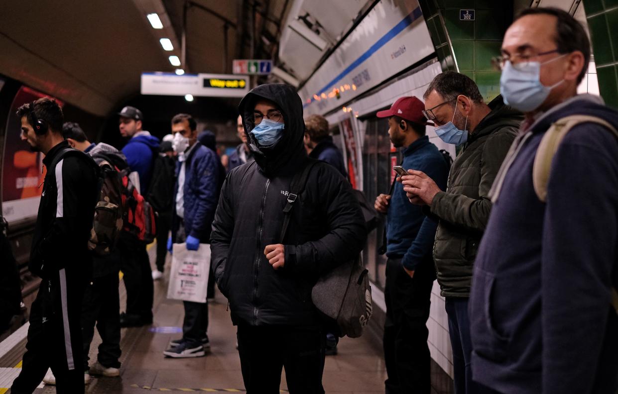 Commuters wearing PPE (personal protective equipment), including a face mask as a precautionary measure against COVID-19, travel in the morning rush hour on TfL (Transport for London) London underground Victoria Line trains from Finsbury Park towards central London on May 13, 2020, as people start to return to work after COVID-19 lockdown restrictions were eased. - Britain's economy shrank two percent in the first three months of the year, rocked by the fallout from the coronavirus pandemic, official data showed Wednesday, with analysts predicting even worse to come. Prime Minister Boris Johnson began this week to relax some of lockdown measures in order to help the economy, despite the rising death toll, but he has also stressed that great caution is needed. (Photo by Isabel INFANTES / AFP) (Photo by ISABEL INFANTES/AFP via Getty Images)