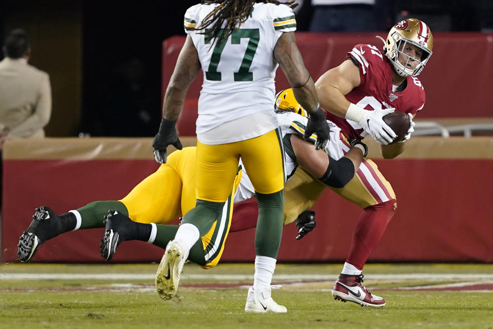 San Francisco 49ers defensive end Nick Bosa, right, is tackled by Green Bay Packers offensive tackle David Bakhtiari after recovering a fumble during the first half of an NFL football game in Santa Clara, Calif., Sunday, Nov. 24, 2019. (AP Photo/Tony Avelar)