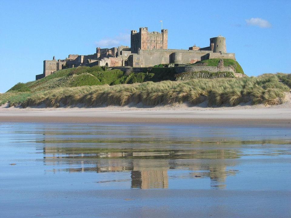 Bamburgh beach is flanked by a castle (Michael Hanselmann/Wikimedia Commons)