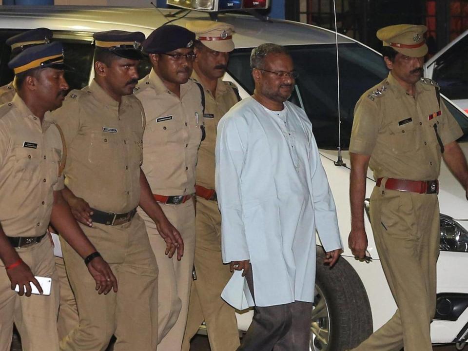 Bishop Franco Mulakkal, dressed in white, is escorted by police in Kochi, India (Reuters)