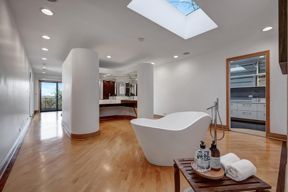 The tub in the primary suite sits directly below a skylight.