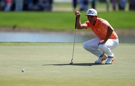 Feb 26, 2017; Palm Beach Gardens, FL, USA; Rickie Fowler prepares to putt on the first hole during the final round of The Honda Classic at PGA National (Champion). Mandatory Credit: Jason Getz-USA TODAY Sports
