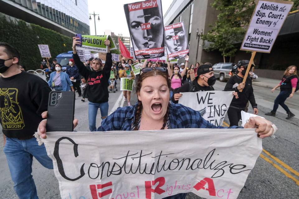 FILE - Demonstrators march down the streets after protesting outside of the U.S. Courthouse in response to a leaked draft of the Supreme Court's opinion to overturn Roe v. Wade, in Los Angeles, March 3, 2022. (AP Photo/Ringo H.W. Chiu, File)