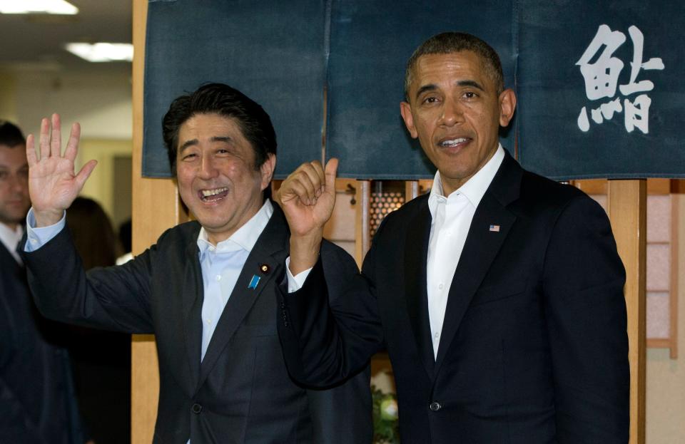 Then President Barack Obama and then Japanese Prime Minister Shinzo Abe depart Sukiyabashi Jiro sushi restaurant in Tokyo, Wednesday, April 23, 2014.