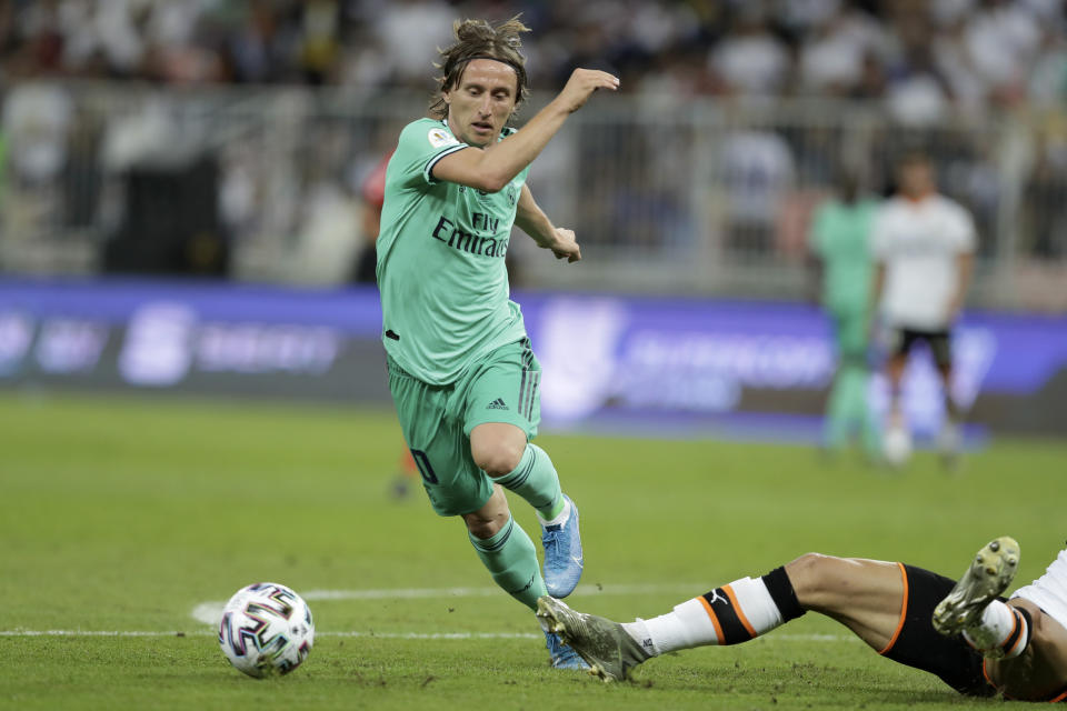 Real Madrid's Luka Modric runs with the ball during the Spanish Super Cup semifinal soccer match between Real Madrid and Valencia at King Abdullah stadium in Jiddah, Saudi Arabia, Wednesday, Jan. 8, 2020. (AP Photo/Hassan Ammar)