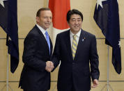 Australian Prime Minister Tony Abbott, left, and his Japanese counterpart Shinzo Abe shake hands prior to a National Security Council meeting at the latter's official residence in Tokyo Monday, April 7, 2014. It is the first time that a foreign leader attends to the meeting. Abbott is currently on a four-day official visit in Japan. (AP Photo/Franck Robichon, Pool)