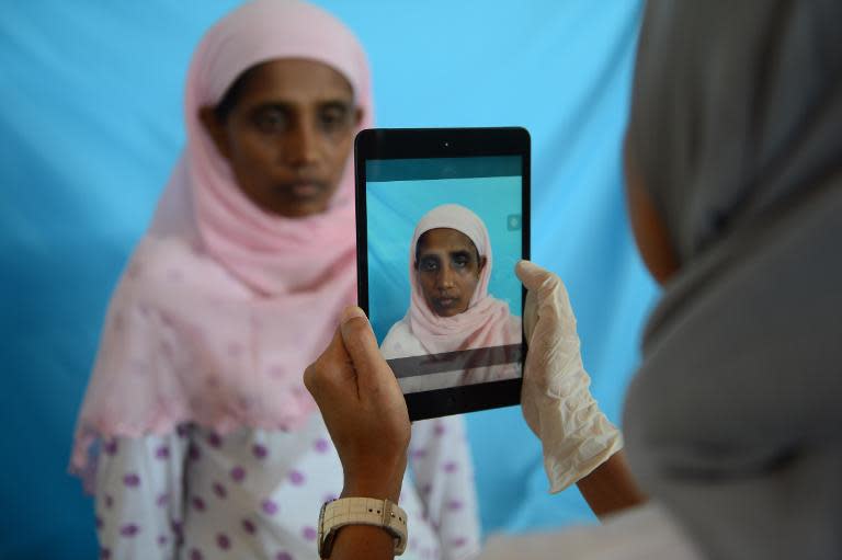 Rohingya woman from Myanmar, Rehana Begum, is photographed during identification procedures by the International Organization for Migration at a confinement area in Langsa, Aceh province on May 19, 2015