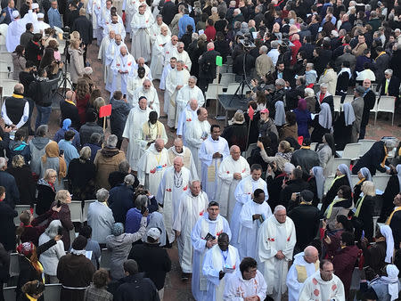 Faithful attend the beatification ceremony for seven monks and twelve clergy, who were killed in Algeria’s civil war, at the Notre Dame de Santa Cruz in the city of Oran, Algeria December 8, 2018. REUTERS/Abdelaziz Boumzar