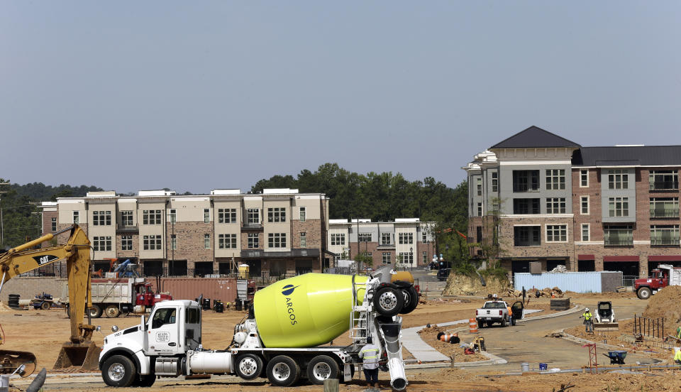 This photo taken Monday, July 1, 2019 shows new construction underway at Carraway Village, a mixed-use community in Chapel Hill, N.C. (AP Photo/Gerry Broome)