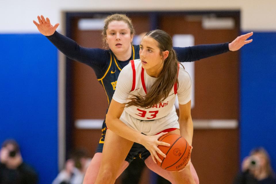 Center Grove High School senior Rachel Wirts (33) is defended by Mooresville High School senior Rachel Harshman (33) during the second half of an IHSAA Class 4A Sectional championship basketball game, Saturday, Feb. 3, 2024, at Mooresville High School. Center Grove won 61-41.