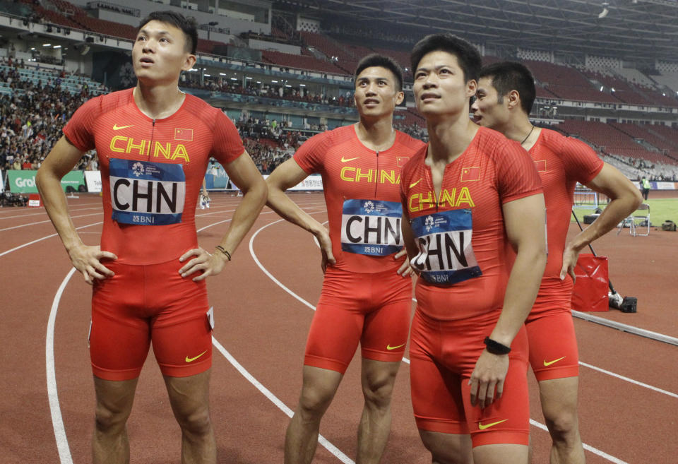 China's men's 4x100m relay team look at the screen after their third place finish during the athletics competition at the 18th Asian Games in Jakarta, Indonesia, Thursday, Aug. 30, 2018. (AP Photo/Lee Jin-man)
