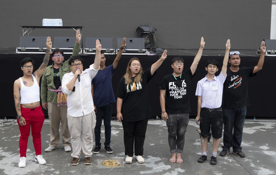 Pro-democracy student leaders raise a three-fingers salute, a symbol of resistance during a protest in Bangkok, Thailand, Sunday, Sept. 20, 2020. Thousands of demonstrators turned out Saturday for a rally to support the student-led protest movement's demands for new elections and reform of the monarchy. (AP Photo/Sakchai Lalit)