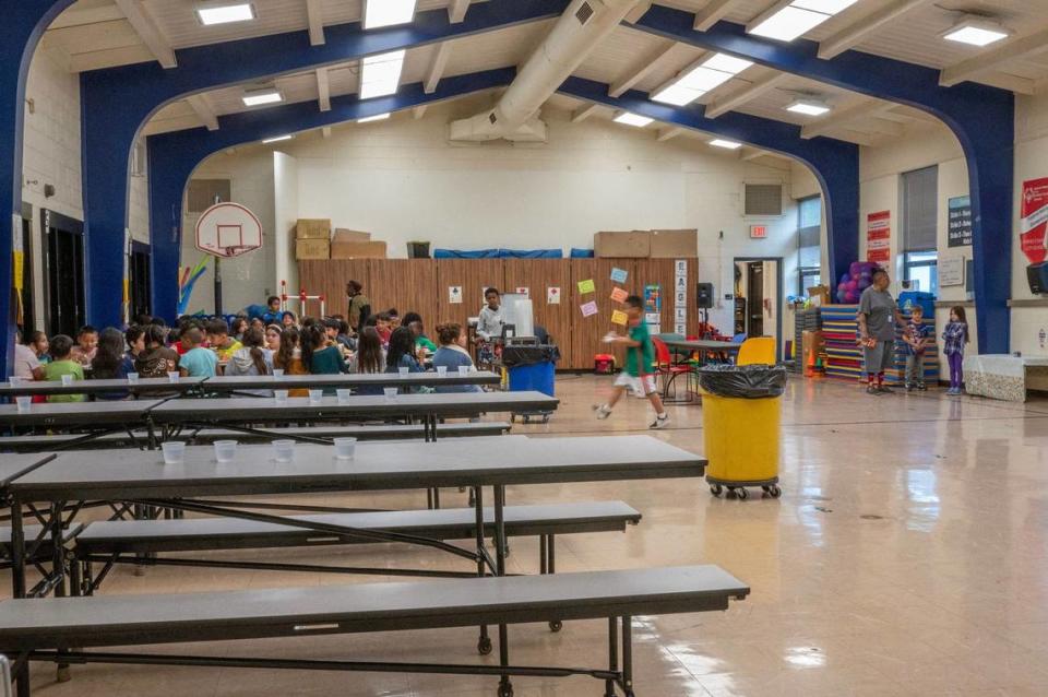 Students dine in the multi-purpose cafeteria, which doubles as a gymnasium, at Eugene Ware Elementary School on Tuesday, April 16, 2024, in Kansas City, Kansas.