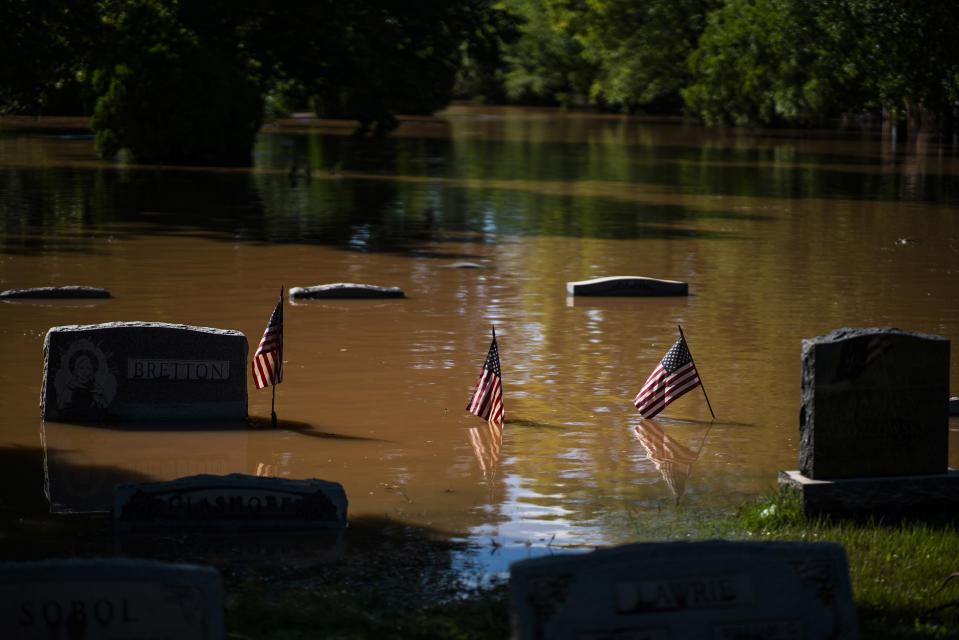 Headstones at a cemetery that flooded are seen in Somerville, N.J. Thursday, Sept. 2, 2021. A stunned U.S. East Coast faced a rising death toll, surging rivers, tornado damage and continuing calls for rescue Thursday after the remnants of Hurricane Ida walloped the region with record-breaking rain, drowning more than two dozen people in their homes and cars. (AP Photo/Eduardo Munoz Alvarez)
