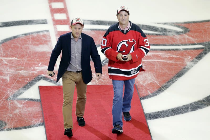 New Jersey Devils owners Josh Harris and business partner David Blitzer drop a ceremonial puck before the Devils play the New York Islanders at The Prudential Center in Newark, New Jersey on October 4, 2013. File Photo by John Angelillo/UPI