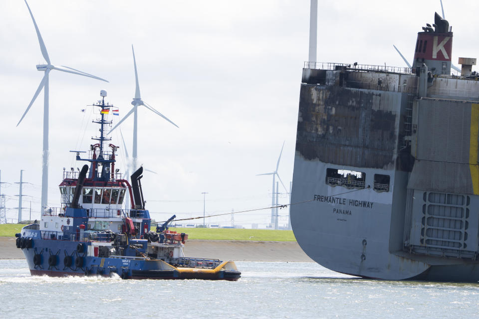 Stricken cargo ship Fremantle Highway, that caught fire while transporting thousands of cars, including nearly 500 electric vehicles, from Germany to Singapore, is towed into the port of Eemshaven, the Netherlands, on Thursday, Aug. 3, 2023. The ship that burned for almost a week close to busy North Sea shipping lanes and a world renowned migratory bird habitat will be salvaged at the northern Dutch port. (AP Photo/Peter Dejong)