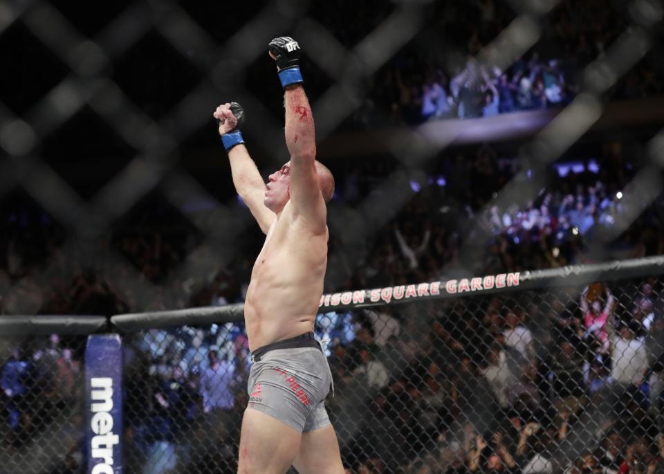 Georges St-Pierre, of Canada, celebrates after winning a middleweight title mixed martial arts bout against England’s Michael Bisping at UFC 217 early Sunday, Nov. 5, 2017, in New York. (AP Photo/Frank Franklin II)