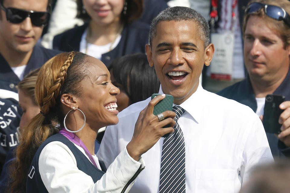 U.S. Olympic 400m sprint gold medalist Sanya Richards-Ross (L) takes a picture with U.S. President Barack Obama as the 2012 U.S. Olympic and Paralympic teams visit the White House in Washington, September 14, 2012. REUTERS/Jonathan Ernst (UNITED STATES - Tags: POLITICS SPORT OLYMPICS TPX IMAGES OF THE DAY)