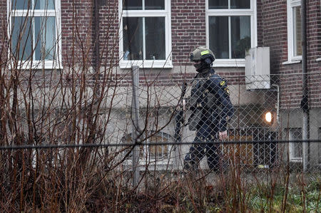 A police officer walks outside Hassleholm Technical School after an explosion, in Hasselholm, Sweden December 20, 2018. TT News Agency/Johan Nilsson via REUTERS ATTENTION EDITORS - THIS IMAGE WAS PROVIDED BY A THIRD PARTY. SWEDEN OUT. NO COMMERCIAL OR EDITORIAL SALES IN SWEDEN.