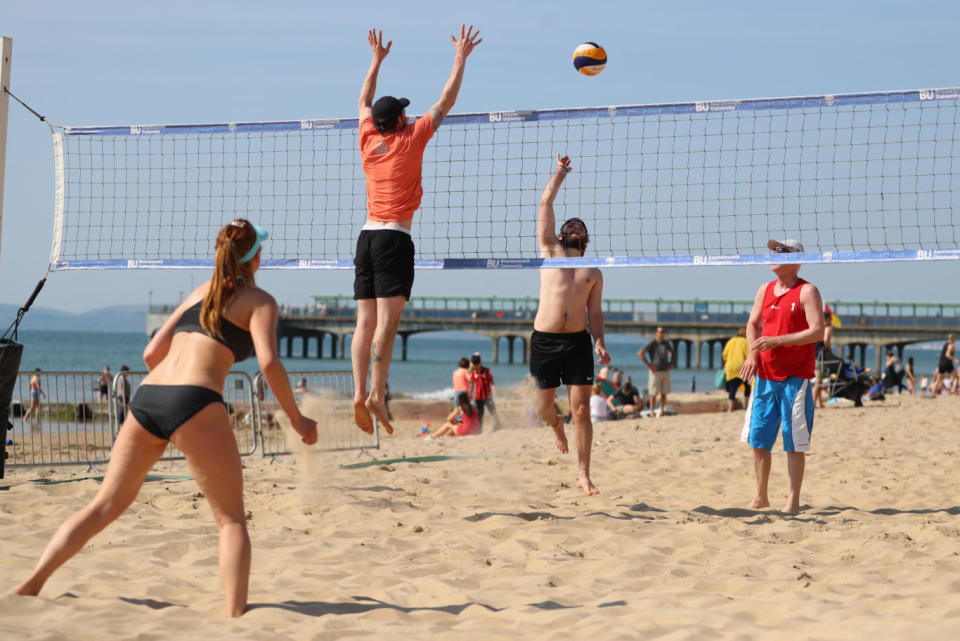 People playing beach volleyball (Andrew Matthews/PA)