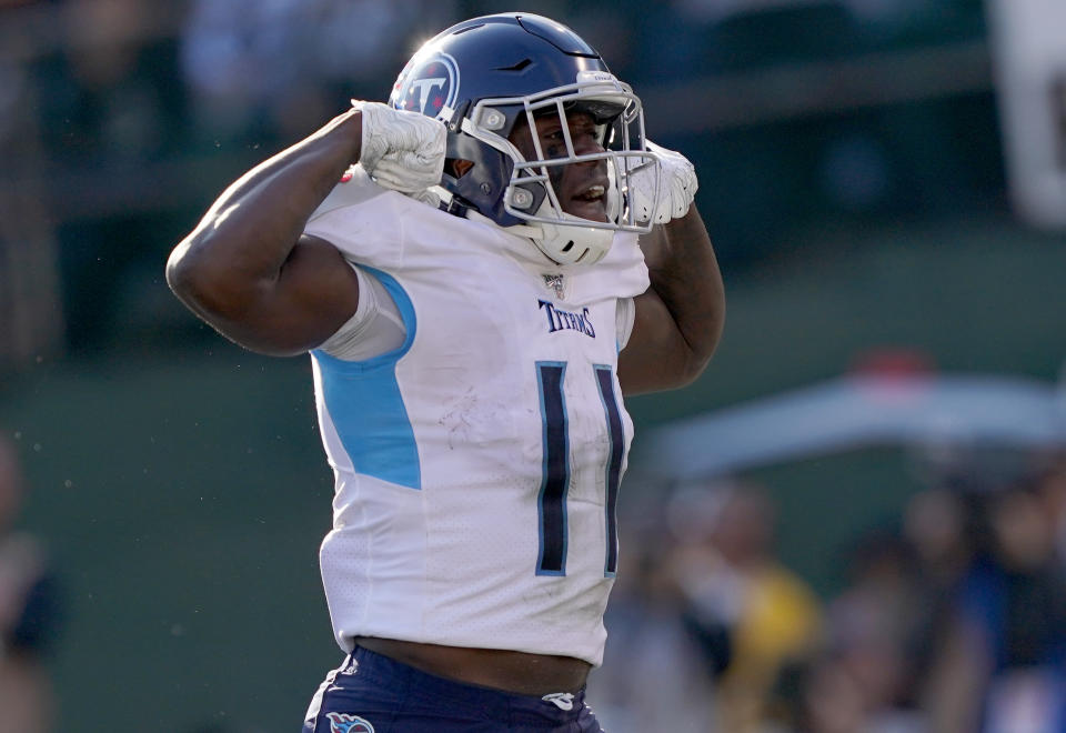 OAKLAND, CALIFORNIA - DECEMBER 08: A.J. Brown #11 of the Tennessee Titans celebrates after he scored a touchdown against the Oakland Raiders during the first half of an NFL football game at RingCentral Coliseum on December 08, 2019 in Oakland, California. (Photo by Thearon W. Henderson/Getty Images)