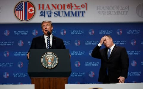 Secretary of State Mike Pompeo looks on as Trump speaks to reporters - Credit: AP