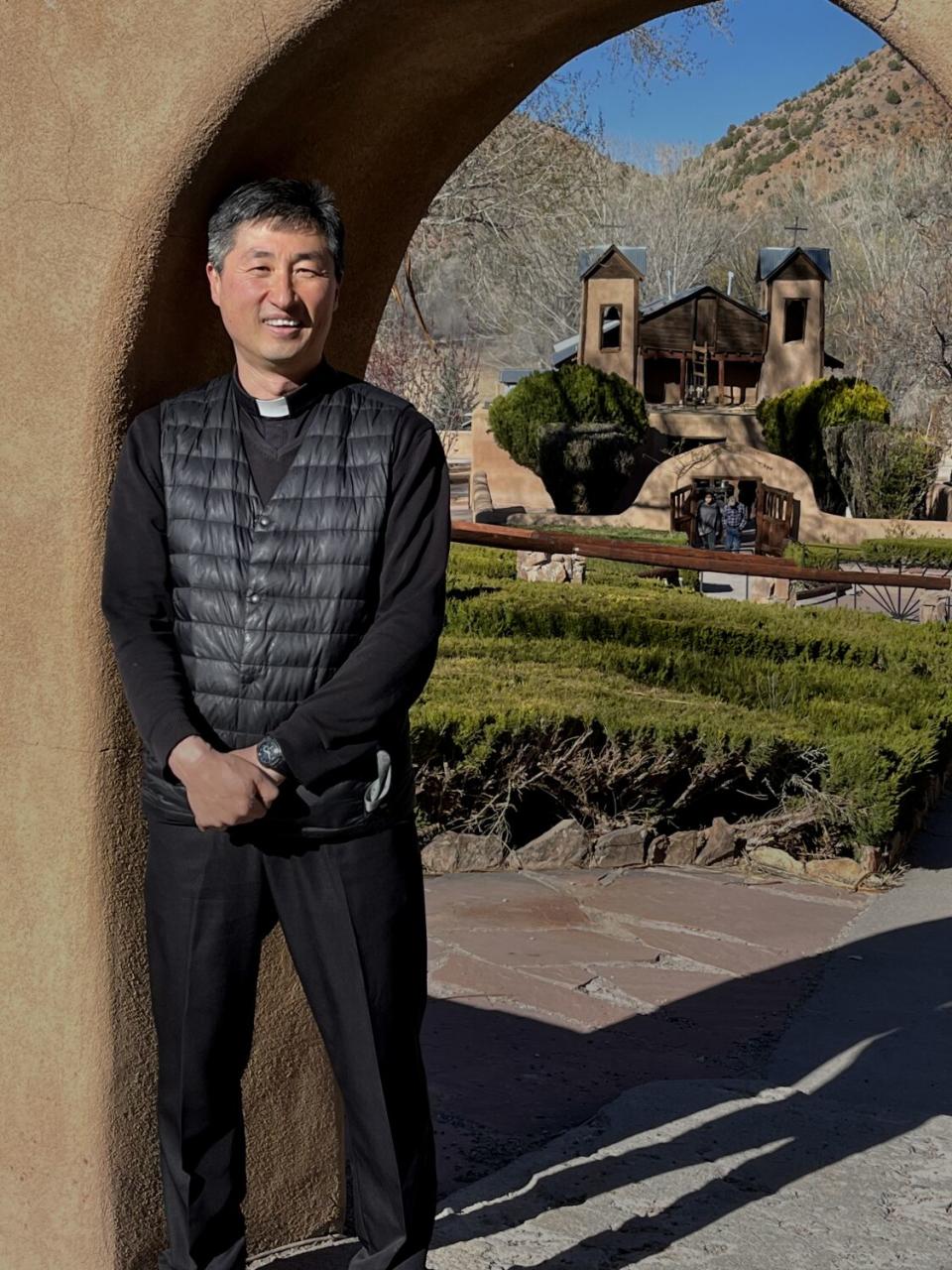 Father Sebastian Lee stands outside Santuario de Chimayo shrine