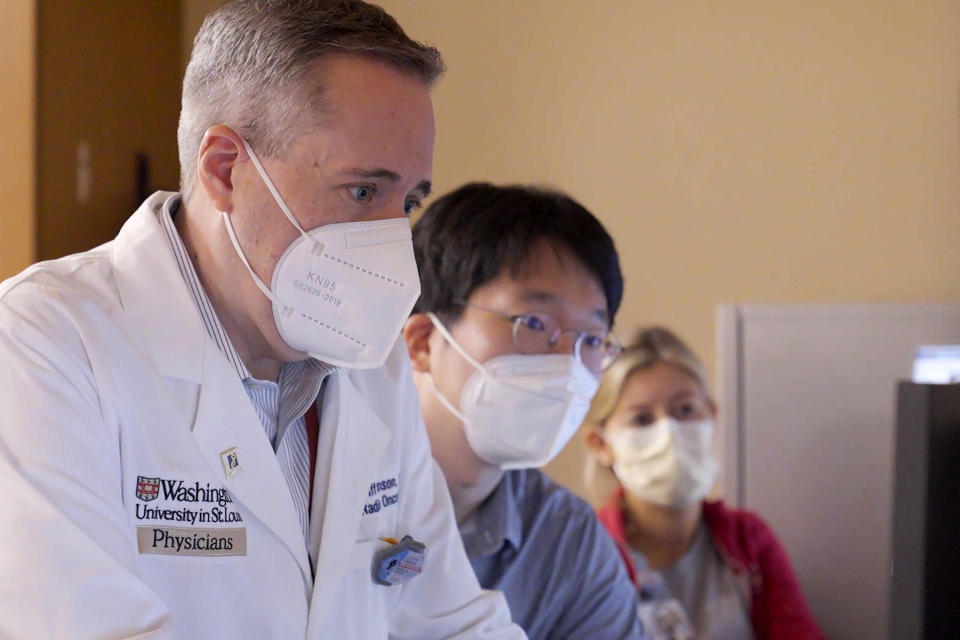 In this photo provided by Washington University, Dr. Clifford Robinson works with others during an experimental treatment using radiation on the heart of Jeff Backus in St. Louis on Tuesday, Feb. 14, 2023. Robinson, who specializes in precisely focused radiation to attack cancer while avoiding nearby healthy tissue, says aiming at the heart “wasn’t on my radar at all. My goal was to miss the heart,” Robinson said. After all, some lung and breast cancer survivors experience heart disease years later from tumor radiation that reached and inflamed heart tissue. (Huy Mach/Washington University, St. Louis via AP)