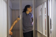 FILE - WNBA star and two-time Olympic gold medalist Brittney Griner listens to the verdict standing in a cage in a courtroom in Khimki just outside Moscow, Russia, Thursday, Aug. 4, 2022. Griner had for years been known to fans of women's basketball, college player of the year, a two-time Olympic gold medalist and WNBA all-star who dominated her sport. But her arrest on drug-related charges at a Moscow airport in February elevated her profile in ways neither she nor her supporters would have ever hoped for, making her by far the most high-profile American to be jailed abroad. (Evgenia Novozhenina/Pool Photo via AP, File)