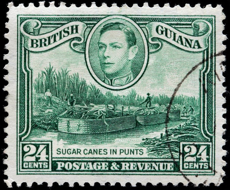 <span class="caption">Stamp printed by British Guyana showing sugar cane being transported in punts, circa 1938.</span> <span class="attribution"><span class="source">Sergey Goryachev via Shutterstock</span></span>