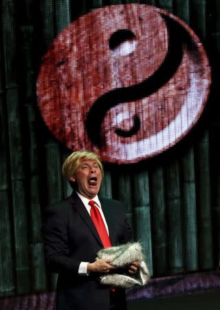 A Mexican comic, dressed as U.S. Republican presidential candidate Donald Trump, pokes fun at the candidate during the show entitled "Sons of Trump" at the Aldana theater in Mexico City, Mexico October 3, 2015. REUTERS/Henry Romero