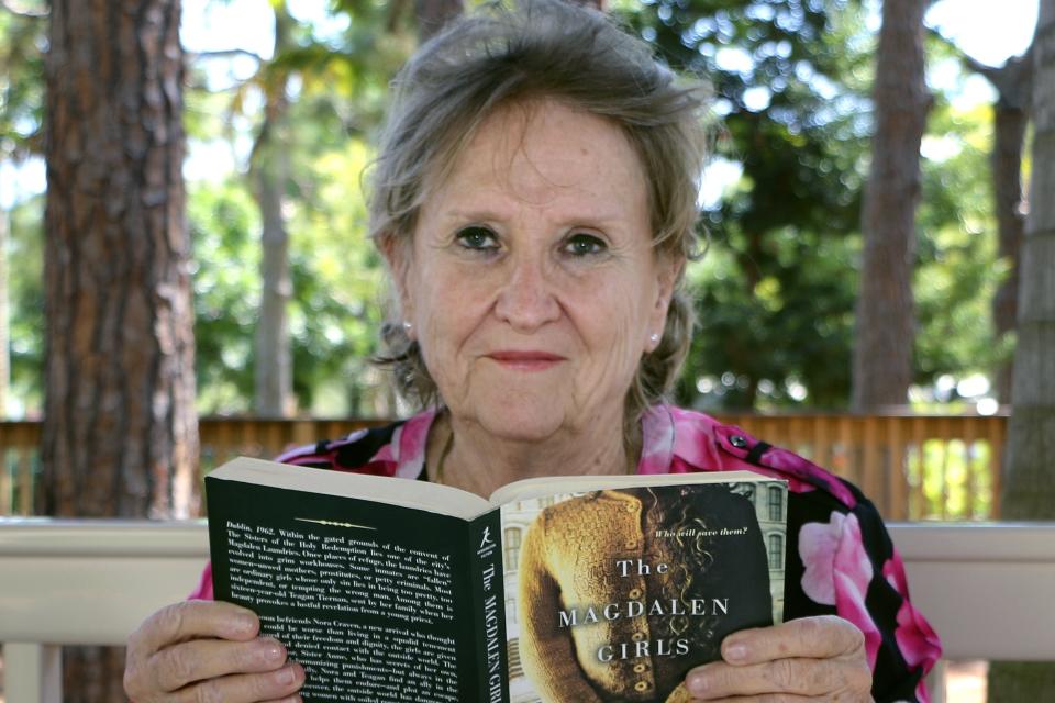 In this March 27, 2020, photo provided by John Knox Village, resident Jeanne Jordan poses for a photo at the retirement community in Pompano Beach, Fla. The retired newspaper editor quickly created a virtual book club when her monthly community gathering was canceled due to the coronavirus outbreak. (John Knox Village via AP)