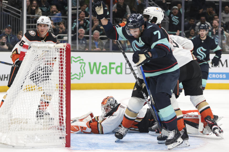 Anaheim Ducks goaltender Lukas Dostal (1), bottom, looks on as Seattle Kraken right wing Jordan Eberle (7) celebrates after a goal by center Matty Beniers (not shown) during the first period of an NHL hockey game Thursday, March 30, 2023, in Seattle. (AP Photo/Jason Redmond)