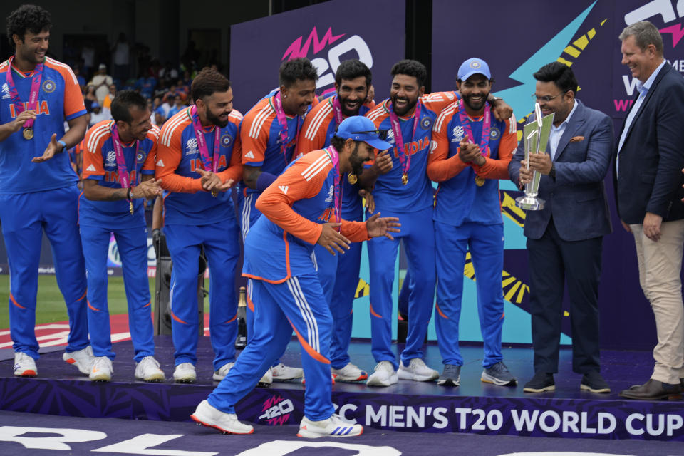 India's captain Rohit Sharma gestures playfully as he walks to collect the winners' after India won the ICC Men's T20 World Cup final cricket match against South Africa at Kensington Oval in Bridgetown, Barbados, Saturday, June 29, 2024. (AP Photo/Ramon Espinosa)