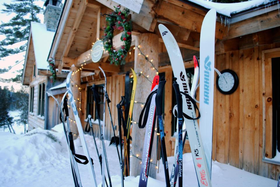 This December 2012 photo shows cross-country skis left by guests outside the Appalachian Mountain Club’s Gorman Chairback Lodge, a backcountry wilderness lodge near Greenville, Maine. In winter, visitors can reach the lodges and cabins only by cross-country skiing in. (AP Photo/Lynn Dombek)