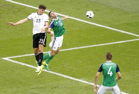 Football Soccer - Northern Ireland v Germany - EURO 2016 - Group C - Parc des Princes, Paris, France - 21/6/16 Germany's Mario Gomez heads at goal as Northern Ireland's Aaron Hughes challenges REUTERS/Charles Platiau Livepic