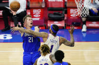 Orlando Magic's Moritz Wagner (21) goes up for a shot against Philadelphia 76ers' Mike Scott (1) during the second half of an NBA basketball game, Sunday, May 16, 2021, in Philadelphia. (AP Photo/Matt Slocum)