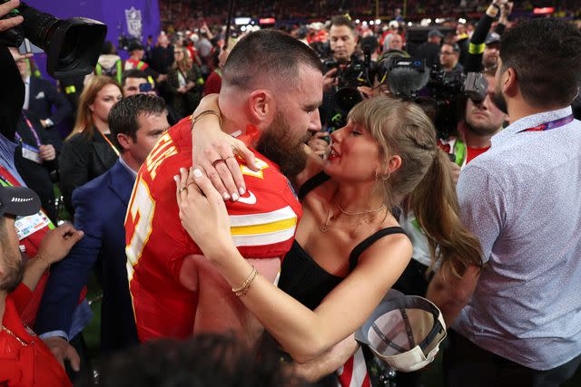 <p>Ezra Shaw/Getty</p> Taylor Swift and Travis Kelce embrace on the field after the Chiefs win Super Bowl LVIII