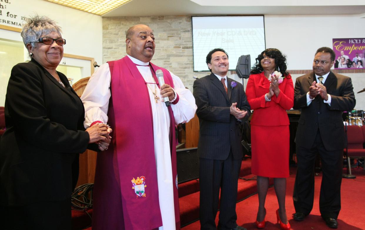 Bishop Sedgwick Daniels prepares to swear in Elizabeth Coggs (in red at right) to the Milwaukee County Supervisor post in 2011 at Holy Redeemer Church in Milwaukee.