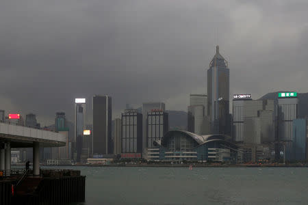 A man stands at a pier facing the island skyline as Typhoon Haima approaches in Hong Kong, China, October 21, 2016. REUTERS/Bobby Yip