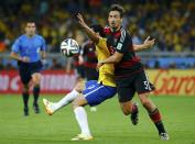 Brazil's Fred (L) fights for the ball with Germany's Mats Hummels during their 2014 World Cup semi-finals at the Mineirao stadium in Belo Horizonte July 8, 2014. REUTERS/Kai Pfaffenbach